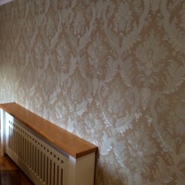 Wallpapering around a radiator in a Dublin home by Abhaile Decorators, Ireland